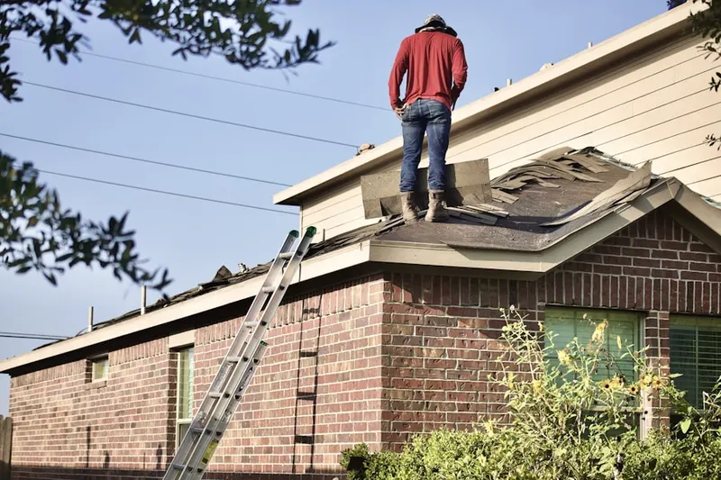 Professional roofer working on a residential roof in Woodstone